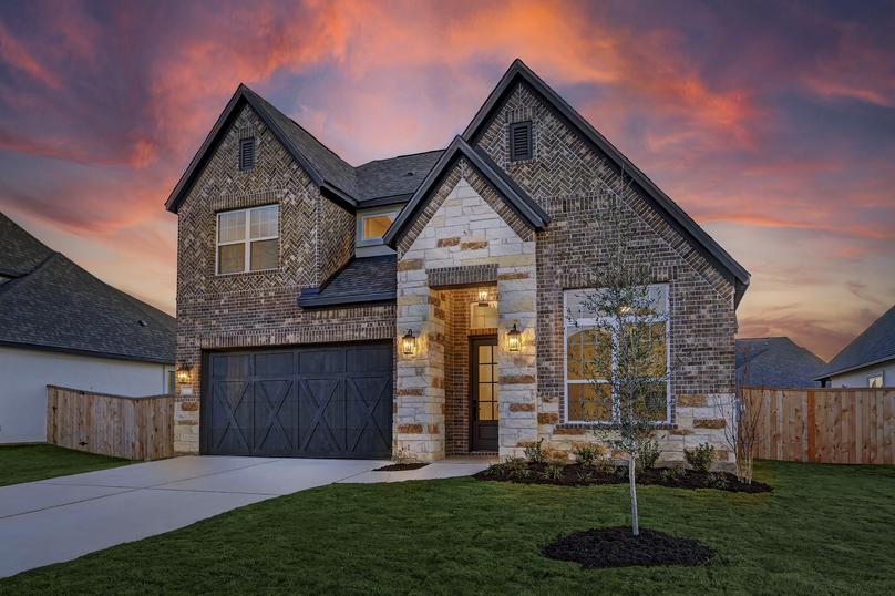 Angled exterior of the Saurel, featuring professional landscaping.