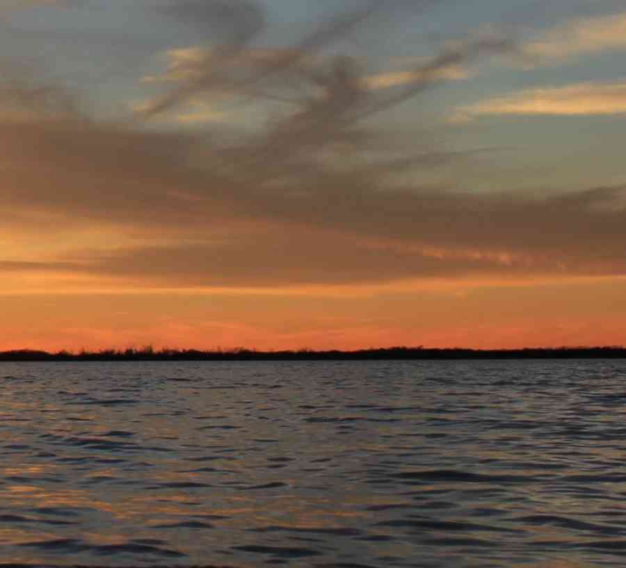 Setting sun behind a lake.