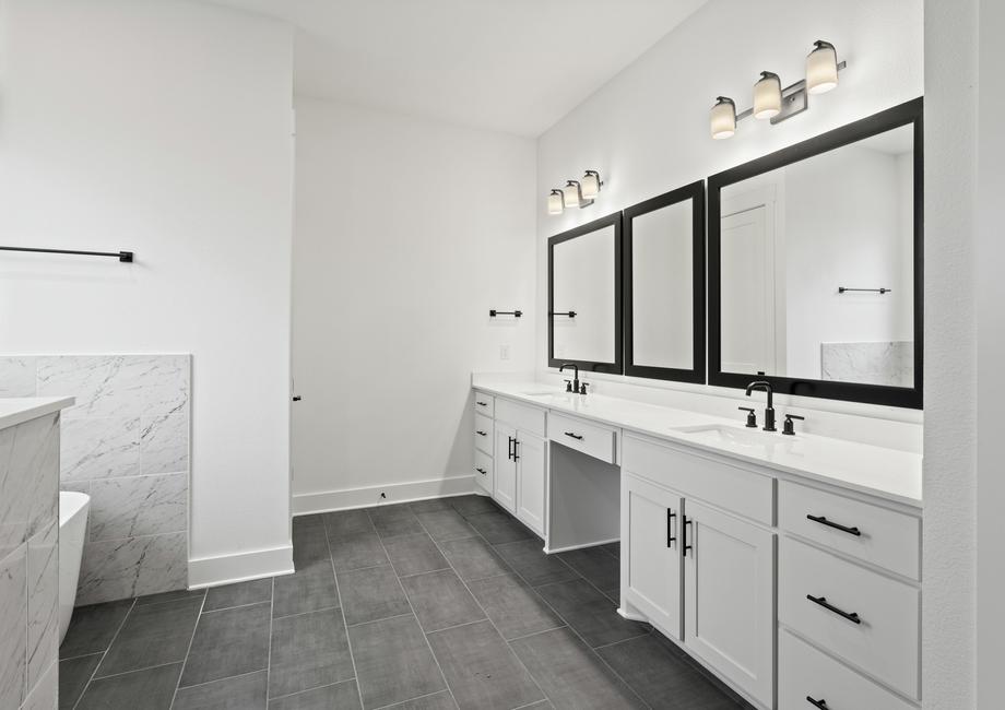 The gorgeous master bathroom has a giant vanity space that has two sinks and vanity space.