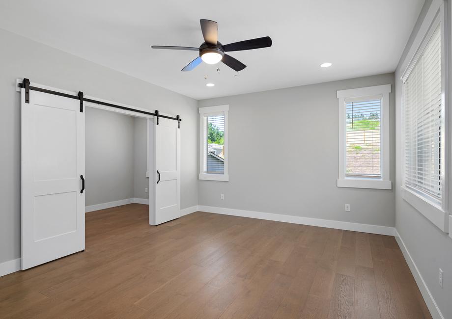 The master bedroom is a dream with wood flooring and a private living area.