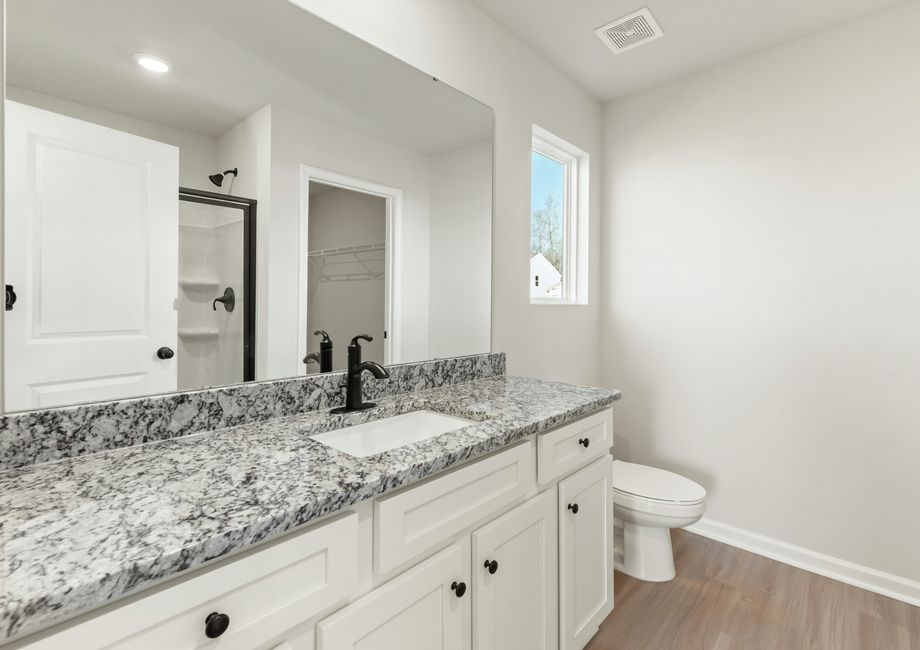 The master bathroom has a glass-enclosed shower