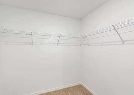 The walk in closet is spacious and ready for your wardrobe