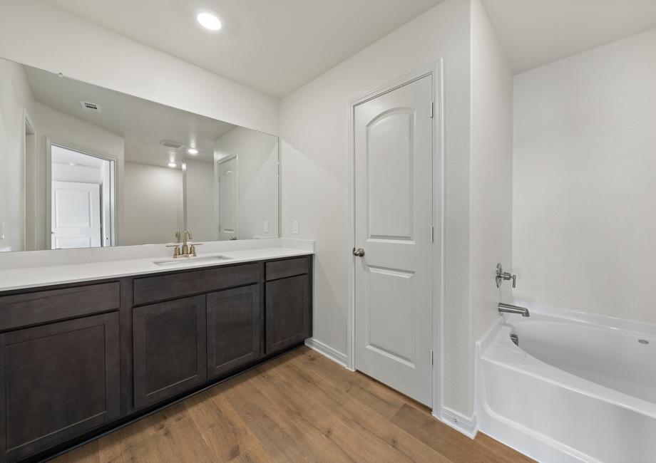 The master bathroom has a large vanity space.