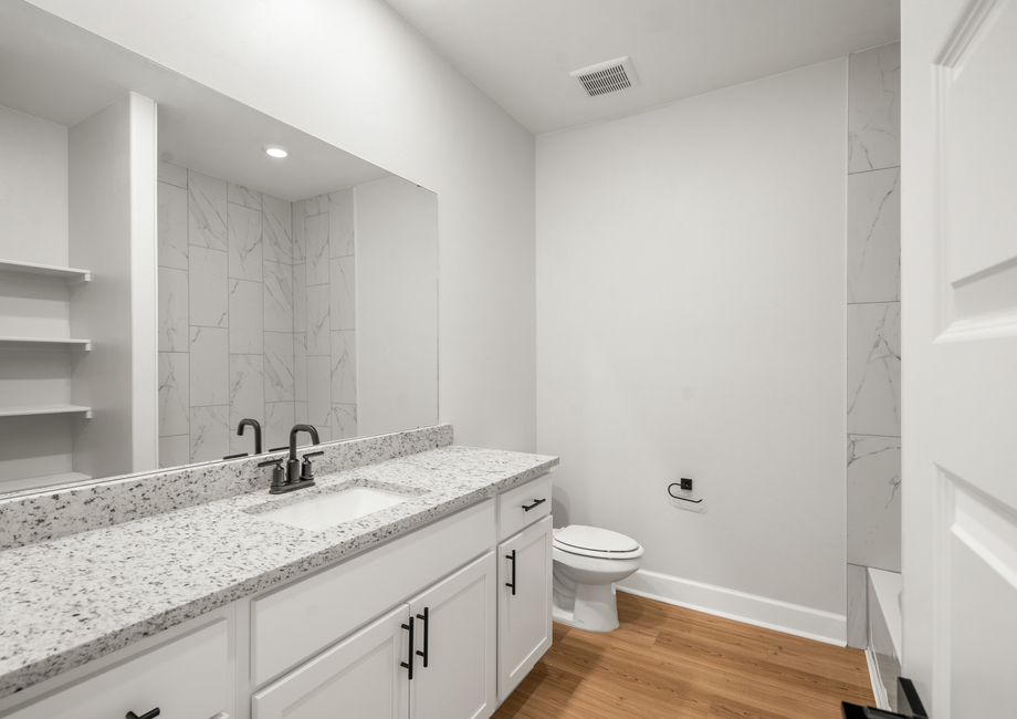 The secondary bathroom has a large vanity with plenty of counterspace.