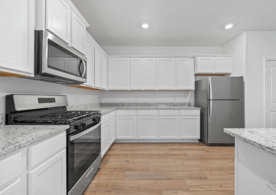 The kitchen comes with white cabinets and granite countertops.