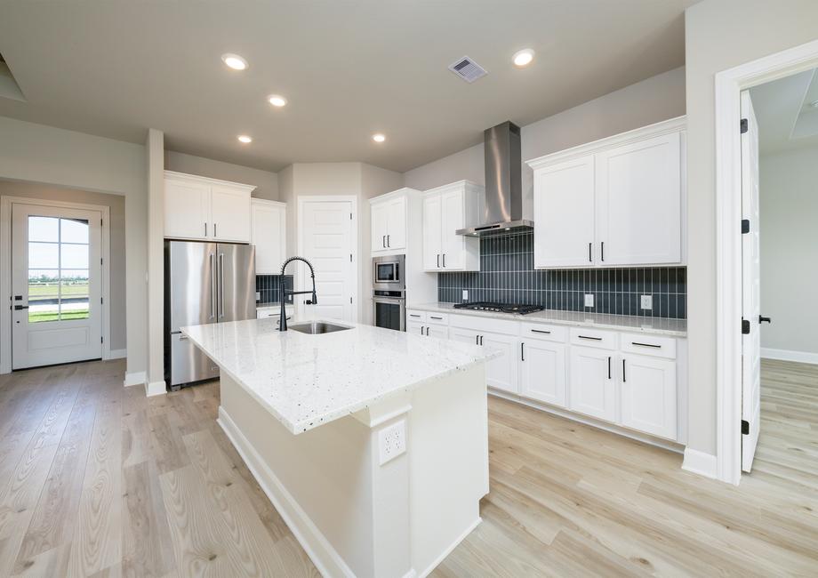 Enjoy a fully loaded kitchen with a modern tile backsplash.