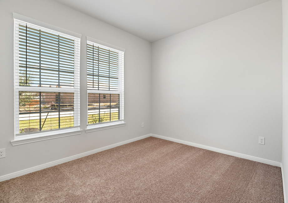 A large window in the third bedroom provides plenty of natural light