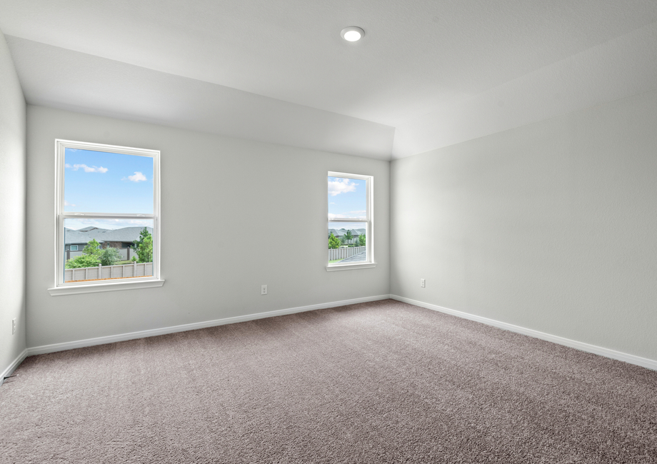 A master bedroom with beautiful windows