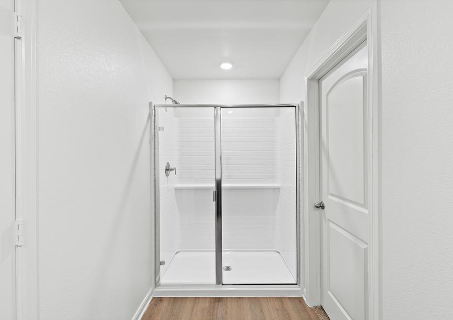 The master bathroom has a large walk-in, glass shower.