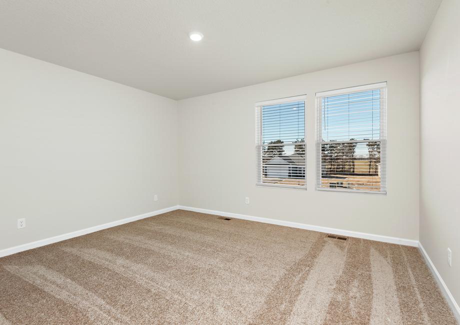 The master bedroom is spacious with a large window.