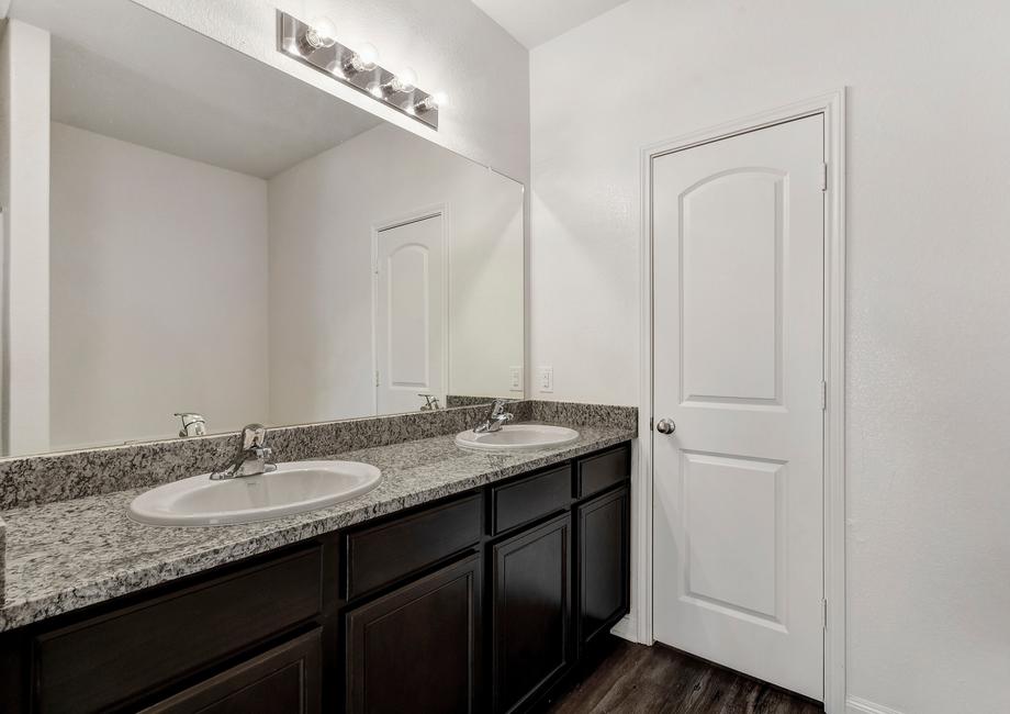 Master bathroom with a dual-sink vanity and granite countertops.