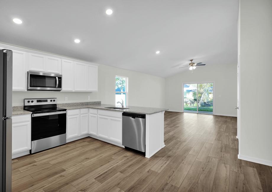 The kitchen overlooks the spacious living area.