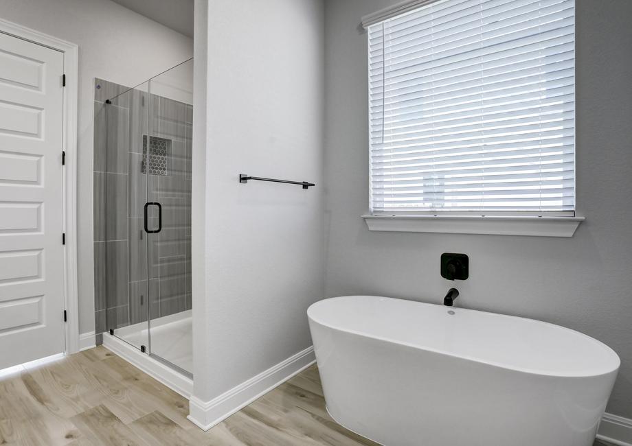 The master bath features a soaking tub and walk-in shower.