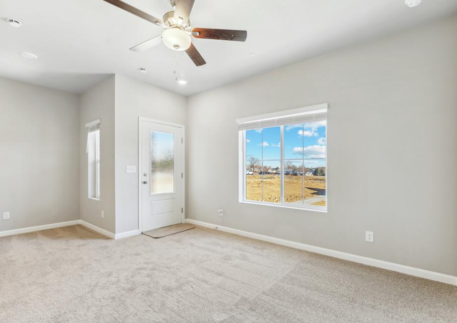 The family room is spacious and has a ceiling fan.