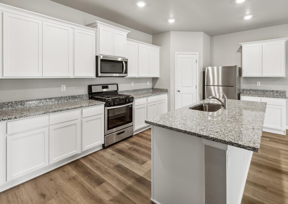 Chef-ready kitchen with a large island, sprawling countertops, and stainless appliances.