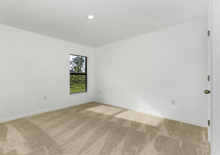 The secondary bedrooms come with tan carpets, closets, and gorgeous windows