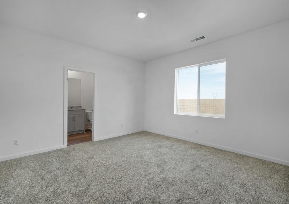 The master bedroom is spacious with a large window.
