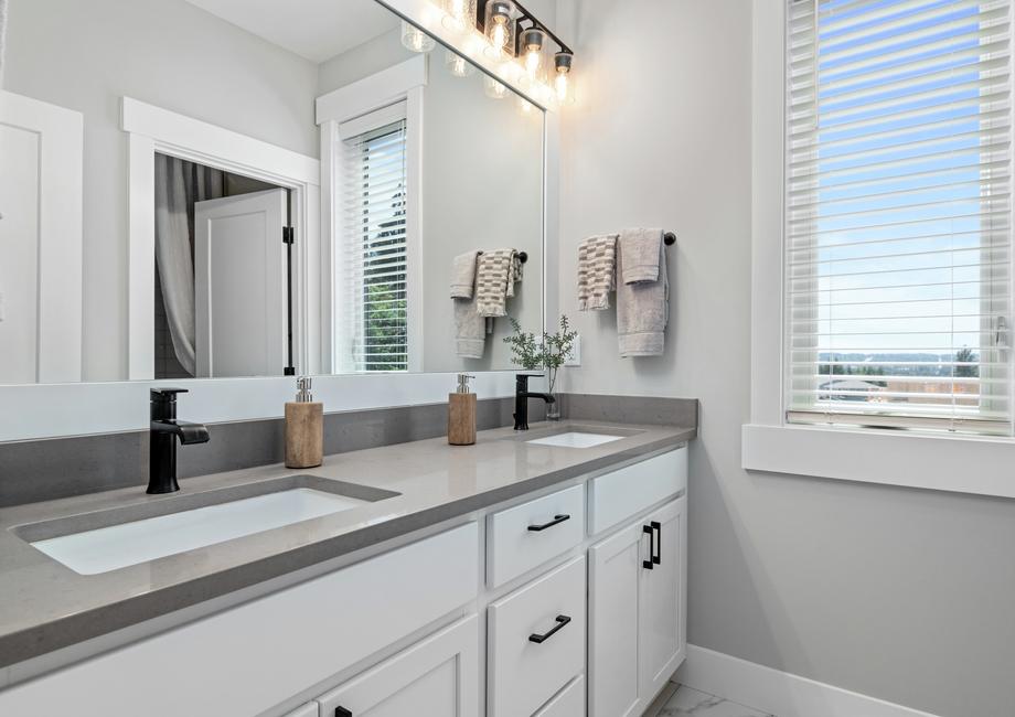 This secondary bathroom has a spacious dual-sink vanity.