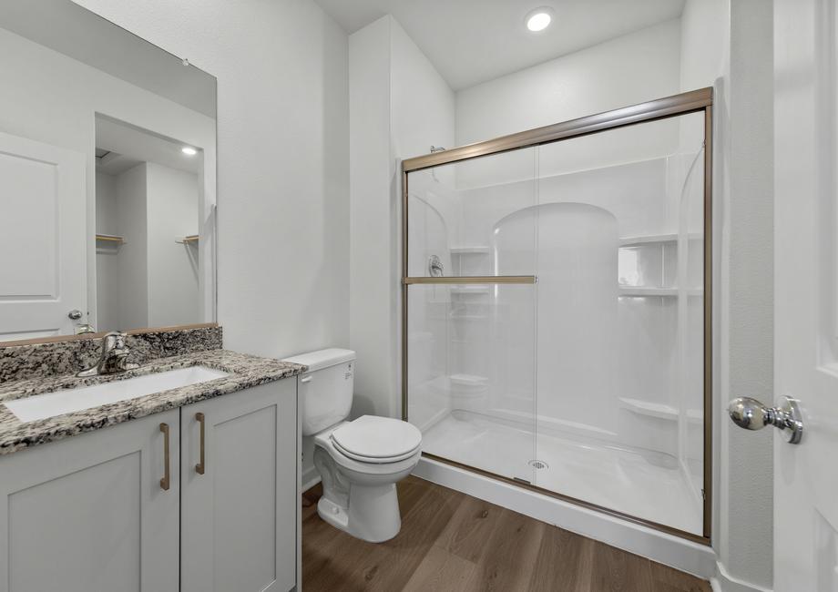 The master bath has a spacious, glass-enclosed shower.