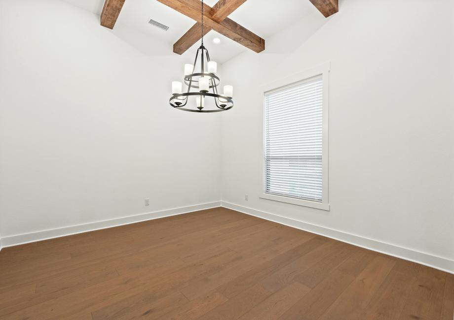 The formal dining room sits right off of the kitchen and has a large window.