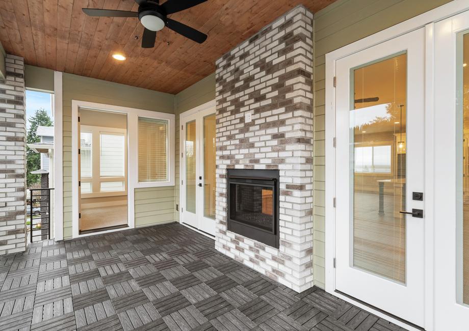 Covered outdoor living area with a fireplace.