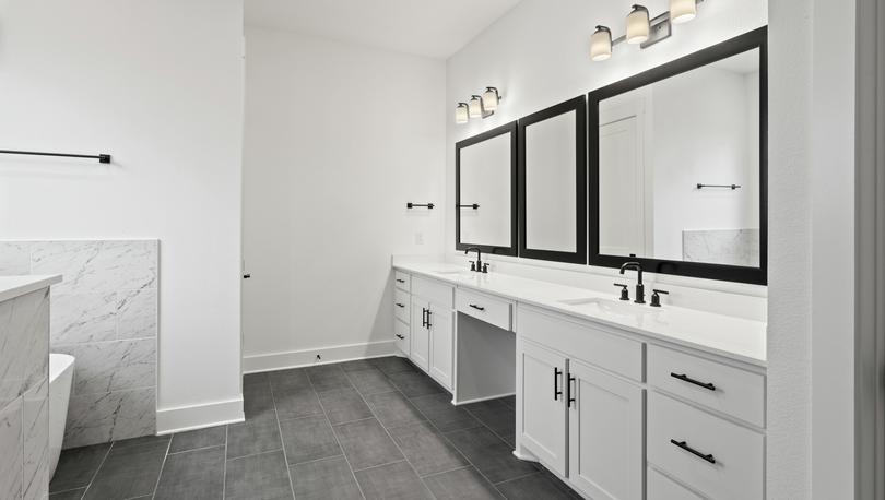 The gorgeous master bathroom has a giant vanity space that has two sinks and vanity space.