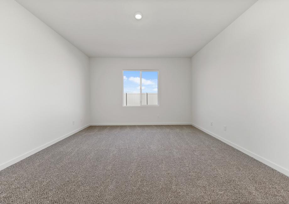 The master bedroom has a large window and is spacious.