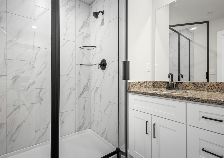 the primary bathroom incldues a stunning walk-in shower