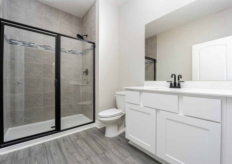 The master bathroom has a spacious vanity and a walk-in shower