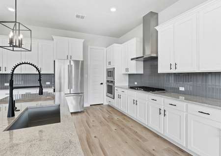 Chef-ready kitchen with stainless appliances and white cabinetry. 