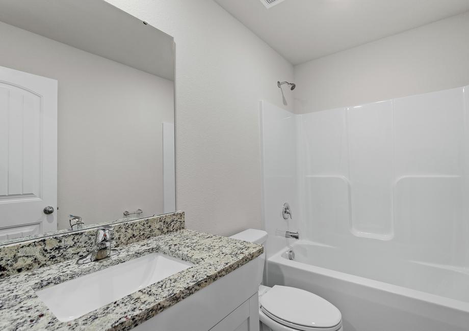 Secondary bathroom with a vanity.