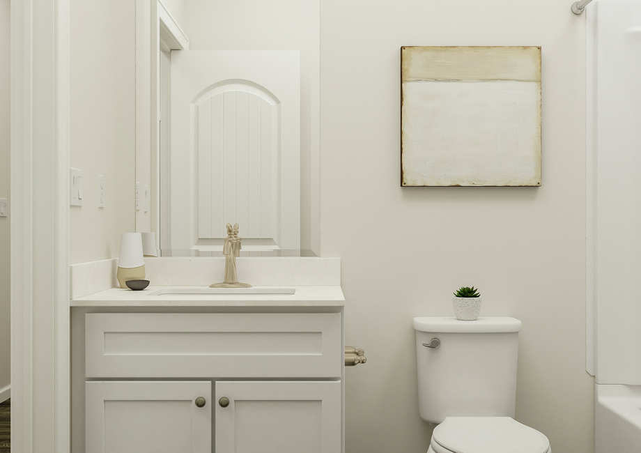 Rendering of a  secondary bathroom featuring bathtub, toilet, vanity with white cabinetry,  and décor.