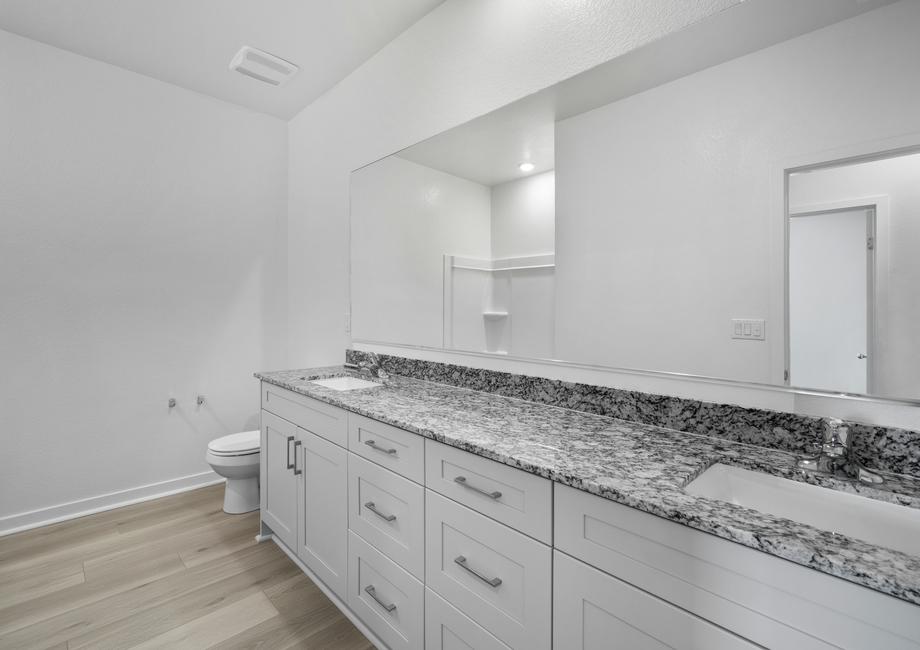 The master bathroom has a dual sink vanity.