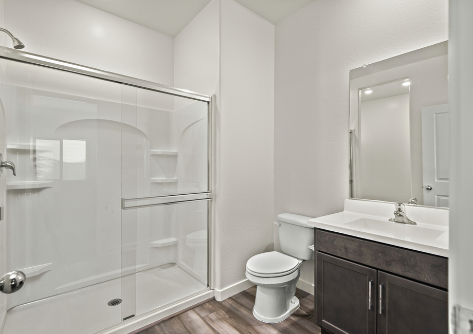 The master bathroom has a glass-enclosed shower.
