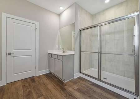 The master bathroom has two separate vanities and a step-in shower 