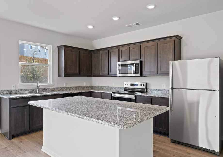 The kitchen has sprawling granite countertops.