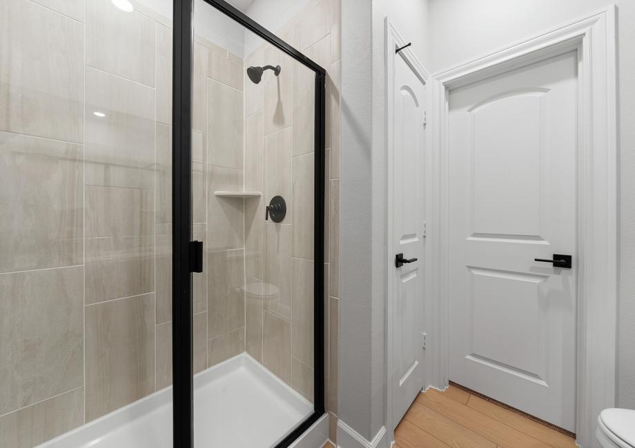 The master bathroom of the Piper has a beautifully tiled walk-in, glass shower.