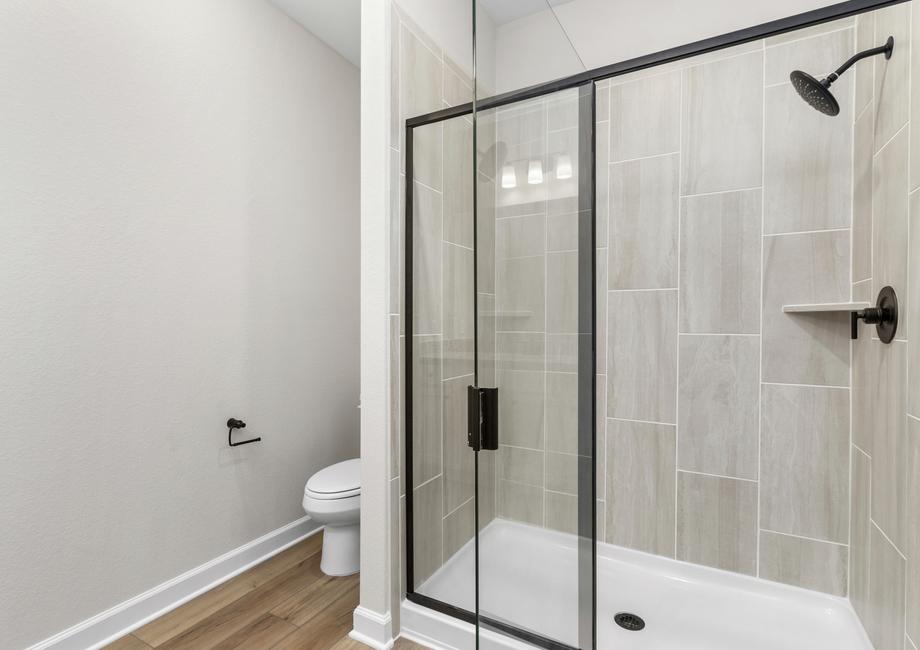 The master bath has a spacious, glass-enclosed shower.