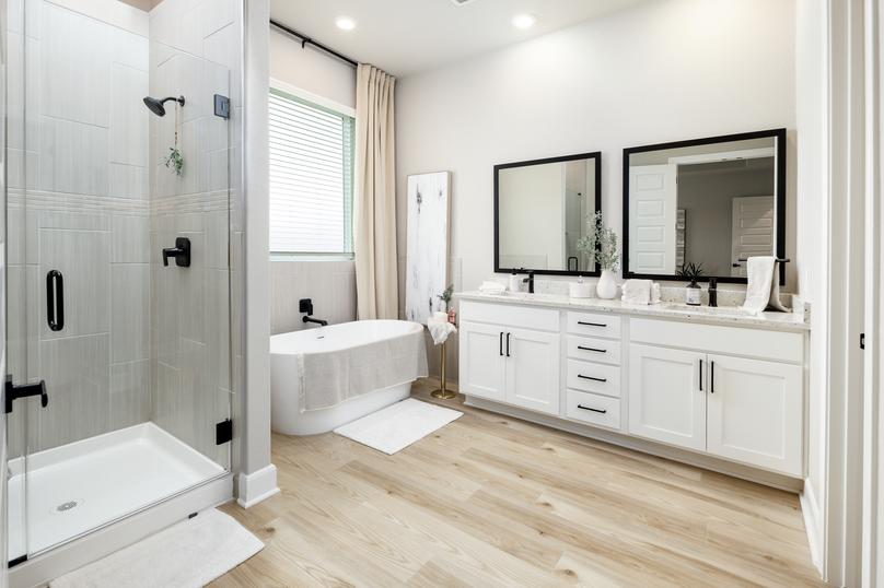 In the master bath you will find a relaxing standalone tub, a walk-in shower and a framed vanity mirror.