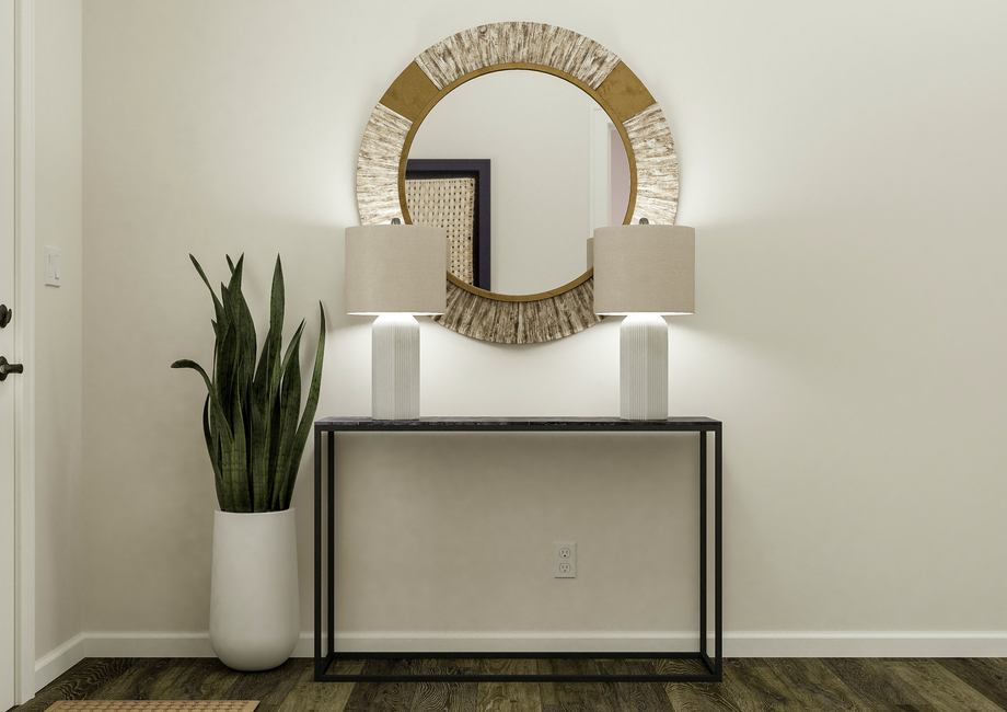 Rendering of the entryway featuring a  table with décor and a view of the front door to the left.