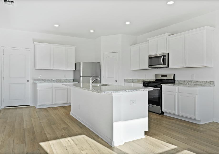 The chef ready kitchen with granite countertops and stainless steel appliances.