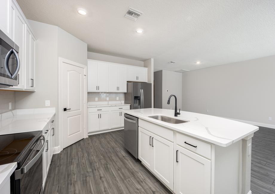 Stainless steel appliances fill the kitchen