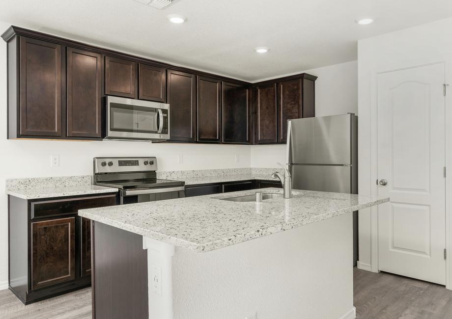 Upgraded kitchen with granite countertops and espresso cabinetry.