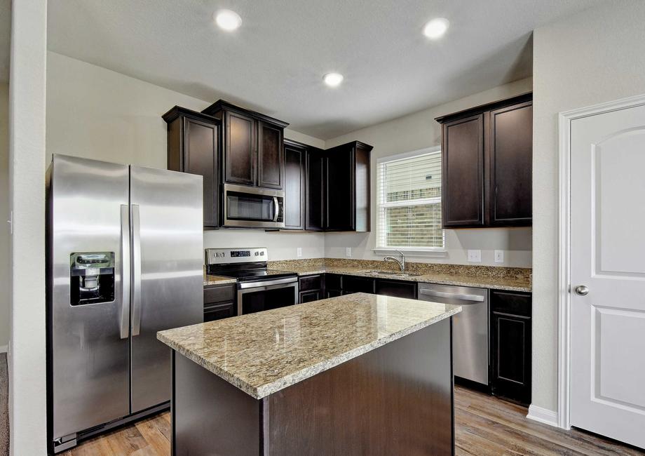 Upgraded kitchen with espresso cabinets and granite countertops.