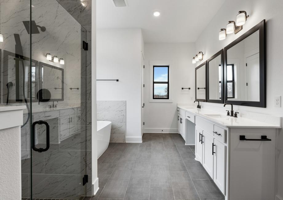 The gorgeous master bathroom has a giant vanity space that has two sinks and vanity space.