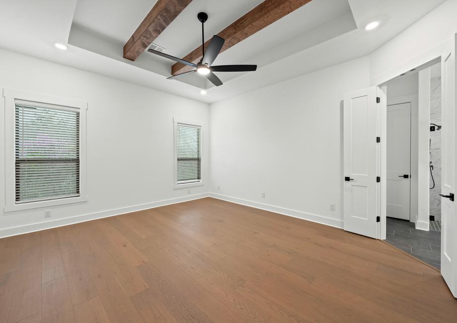 The peaceful master bedroom has two large windows that let in great, natural light.