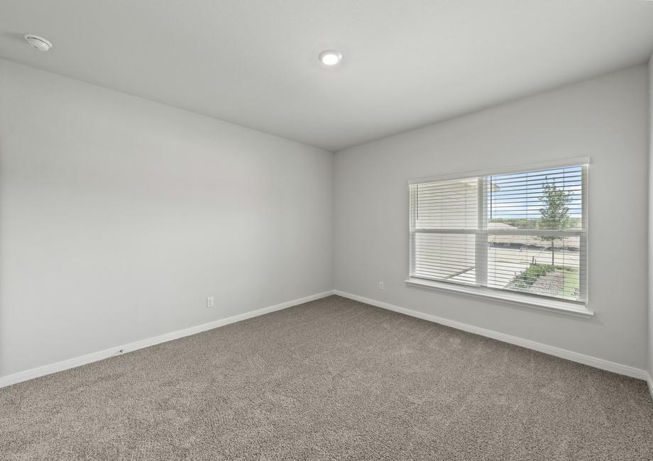 The master bedroom has a large window with wonderful natural light.