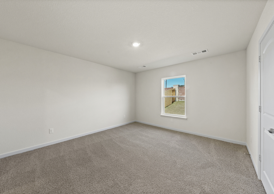 The master bedroom is spacious and has a large window.
