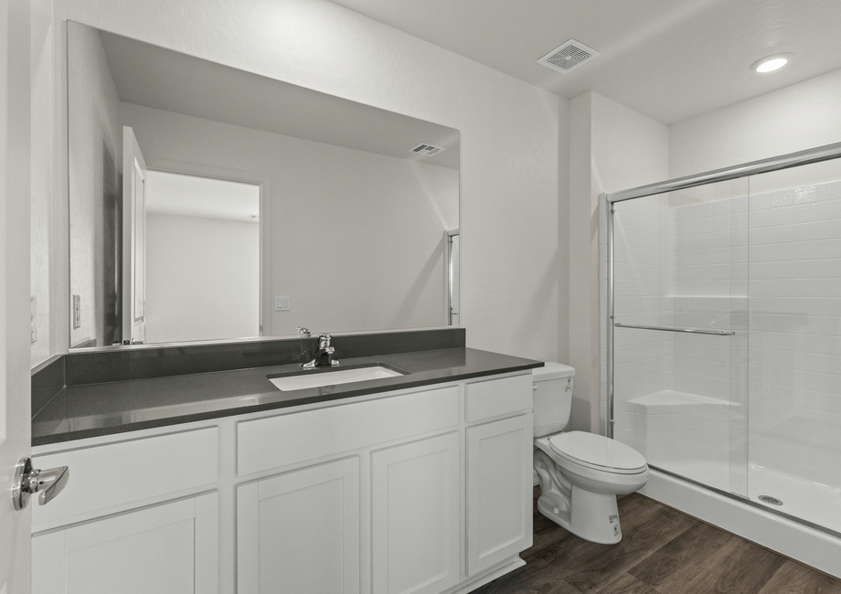 The master bathroom of the Cypress has a large vanity space and glass, walk-in shower.