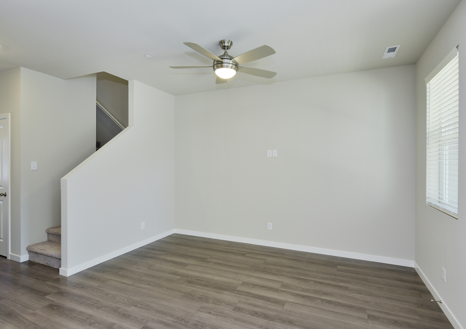 The family room is spacious and ceiling fan.